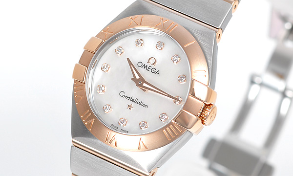 The white dial fake watch has diamond hour marks.